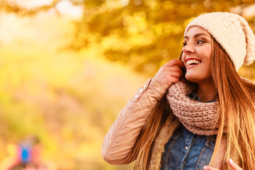 Smiling woman relaxing outdoor in autumnal park