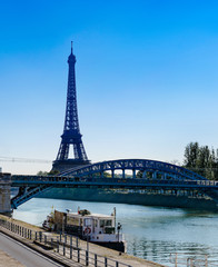 Fototapeta na wymiar Eiffel Tower and Bridge Rouelle over Seine River in Paris, France