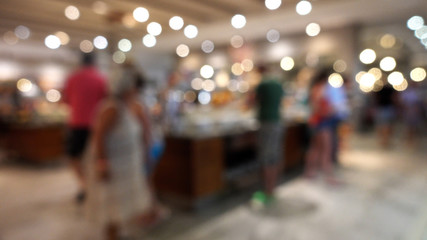 Bokeh, lights, defocused image of people in the restaurant buffet.