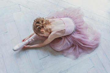 Young classical ballet dancer girl in dance class. Beautiful graceful ballerine practice ballet...