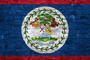 Flag of Belize over an old brick wall background, surface
