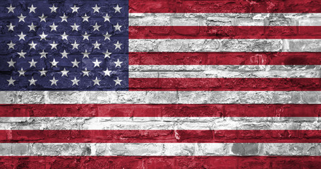 Fototapeta premium Flag of United States of America over an old brick wall background, surface. USA flag