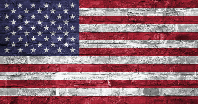 Flag of United States of America over an old brick wall background, surface. USA flag