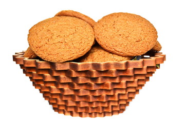 Gingerbread cookies in a beautiful decorative wicker wooden patterned basket on a white background. Isolated