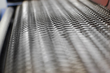 Roller conveyor in print plant, abstract background, selective focus