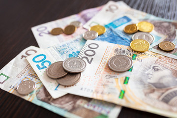 Stack of polish zloty banknotes and coins