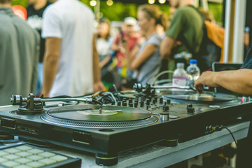 dj hands play music vibes on a summer beach party using a vintage deck setup turntable