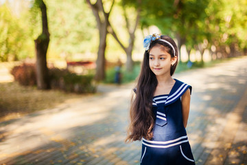 Portrait of little girl in autumn park