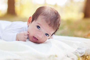 Adorable beautiful newborn baby in the park