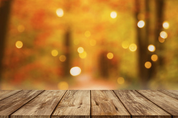 wooden table with blurred autumn forest background