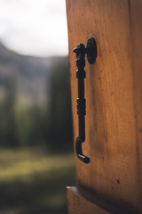 Close up on a cabin door looking out into a forest in Colorado. 