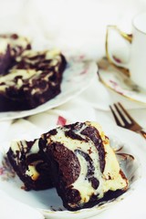 Homemade Cheesecake Swirl Brownies served in a dessert plate, close up