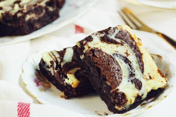 Homemade Cheesecake Swirl Brownies served in a dessert plate, close up