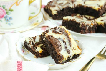 Homemade Cheesecake Swirl Brownies served in a dessert plate, close up