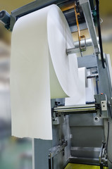 View of rotation machine in Printing house. Part of machine that is called the star, it changes rolls of paper continuously