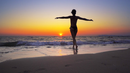 Fashion model woman walk into ocean sunset water with hands wide open, FREEDOM CONCEPT, steadicam cinematic shot