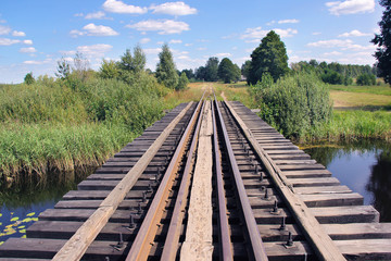 Fototapeta na wymiar bridge over a pond for a train