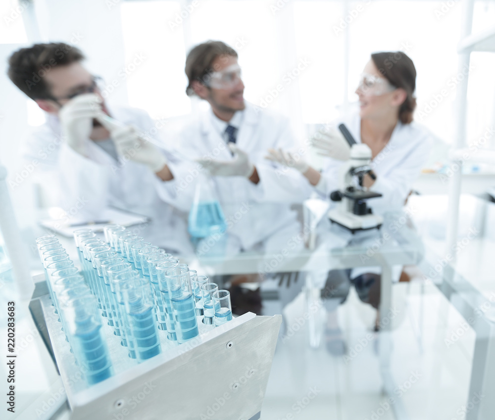 Wall mural background image of scientists studying blue liquid in a flask