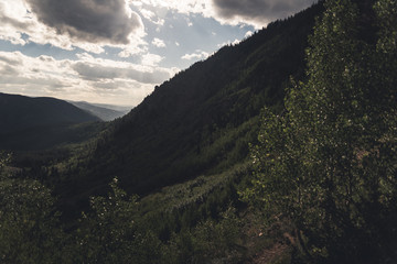 Landscape view with cloud shadows over a forested Valley near Vail, Colorado. 