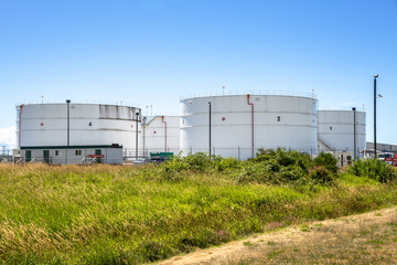 Fototapeta na wymiar Tanks for Fuel Storage near an Airport on a Clear Summer Day