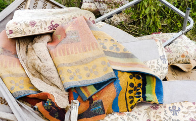 Heap of illegally dumped household rubbish left in a little used country lane. Environmental hazard, with furniture. mattresses and carpets. Fly tipped detritus. Oxfordshire.