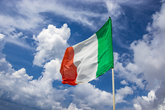 Italian flag waving in the blue sky