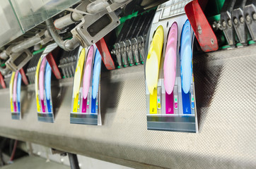 Brochure and magazine stitching process. Close-up of the offset conveying process of a full-automatic stitching unit.