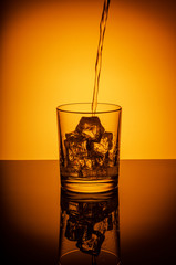 A drink that pours into a glass with ice.
