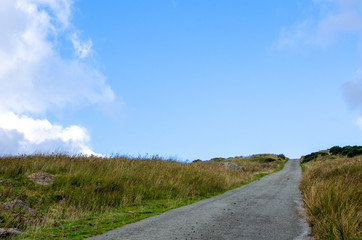 A country road under a blue sky. Photo taken in Snowdonia, Wales