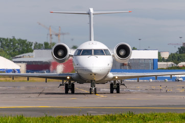 Obraz premium Airplane taxiing on the apron of the airport on the asphalt is visible marking.