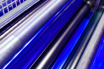 print machine printing press rollers, red magenda color drum, dramatic light