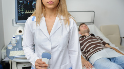 The doctor using the ultrasonography device
