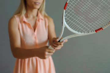 A pretty blonde girl with tennis palette
