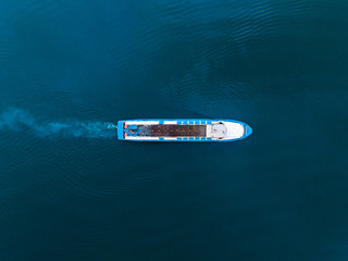 Top view drone of white boat sailing in blue sea