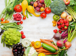 Colourful farm fruits vegetables berries, apples cherries peaches strawberries cabbage broccoli cauliflower squash tomatoes carrots spring onions beans beetroot, copy space, top view