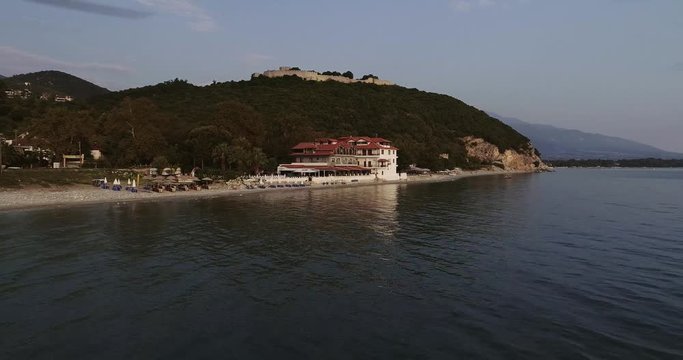 Aerial view of a seaside beautiful village with calm sea on a sunny day.