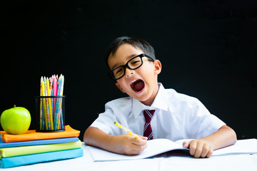 Smart preschool or first grade school boy in white shirt with eye glasses