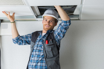 electrical worker wiring in ceiling