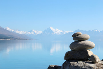 Stones stacked at lake and mountain in New Zealand