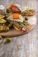 Italian sandwiches with mushroom pate, vegetables and cheese. Mediterranean traditional cuisine. Vertical shot