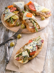 Italian sandwiches with mushroom pate, vegetables and cheese. Mediterranean traditional cuisine. Vertical shot