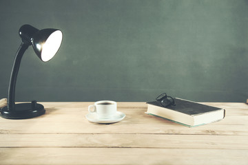 books and coffee with lamp on table