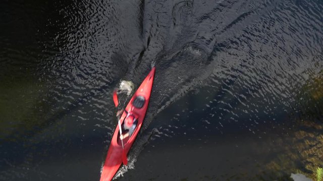 Aerial View on Kayaker in a Red Kayak on Scenic River