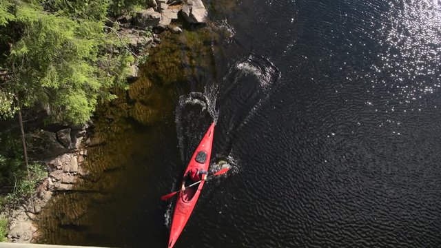 Scenic River Kayaking Aerial View. Caucasian Men Paddling in a Kayak.