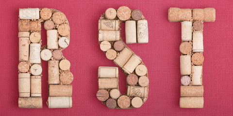 Alphabet letter R, S, T  made of wine corks on red Bordeaux background. ABC set, Burgundy color and wine berry