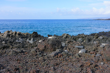 View of black lava rock and blue ocean at the Ahihi-Kinau Natural Area Reserve, on the West shore of Maui south of Wailea and Makena, Hawaii