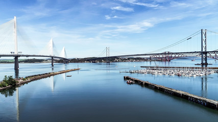 Aerial image looking over the marina at South Queensferry to the Forth road and rail bridge and new...