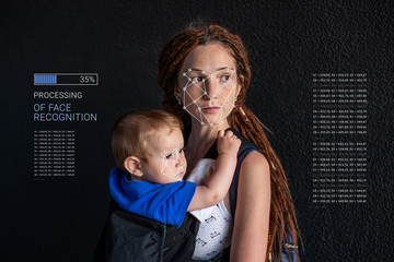 Biometric verification. Modern young woman with a child. New technology of face recognition and...