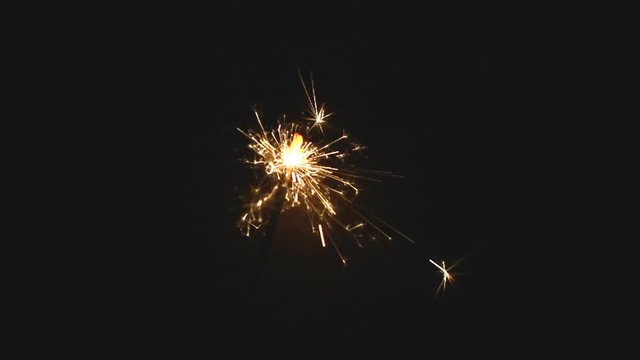 Christmas sparkler on black background, slow motion
