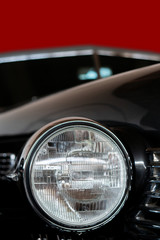 Headlight of an antique, rarity, vintage black car.